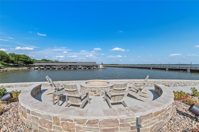 exterior space with a water view and a fire pit