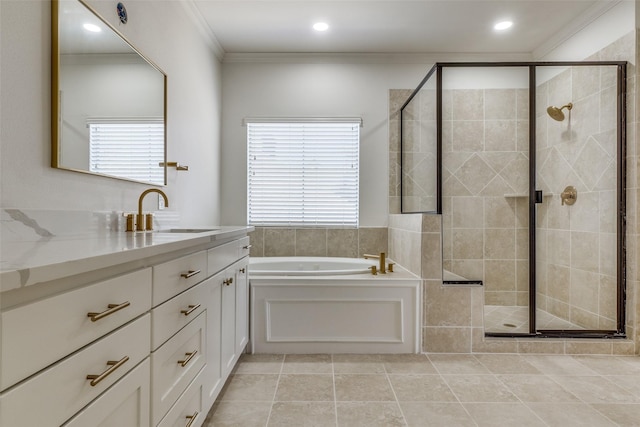 bathroom featuring plus walk in shower, crown molding, tile patterned flooring, and vanity