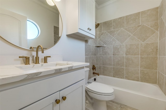 full bathroom featuring toilet, vanity, crown molding, and tiled shower / bath combo