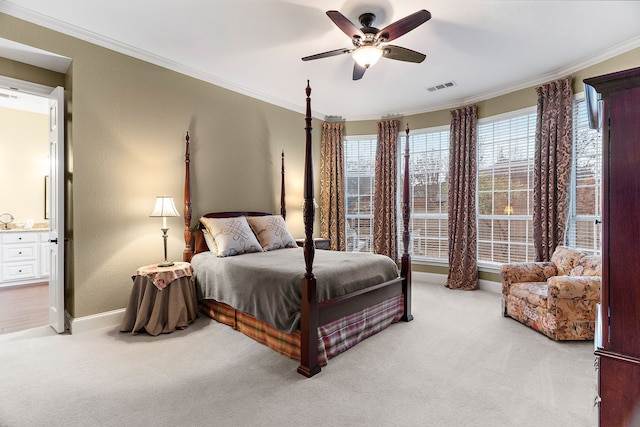 carpeted bedroom with ceiling fan, ornamental molding, and connected bathroom