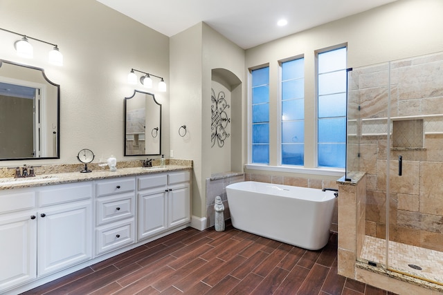 bathroom with vanity and shower with separate bathtub