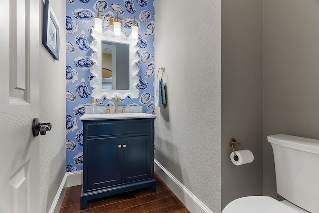 bathroom featuring hardwood / wood-style flooring, vanity, and toilet