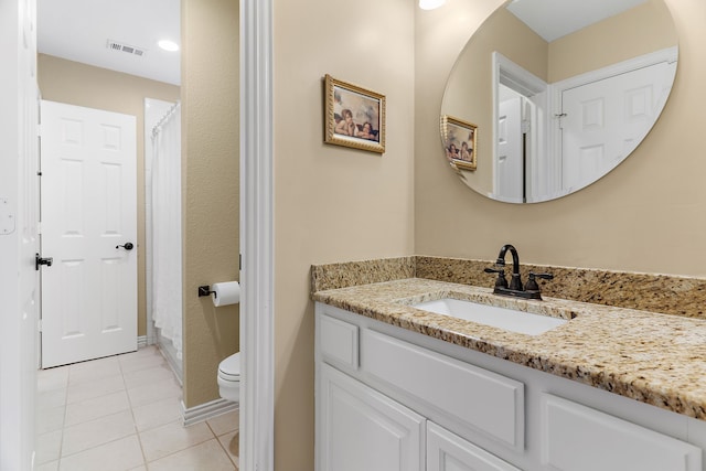 bathroom featuring tile patterned floors, toilet, and vanity