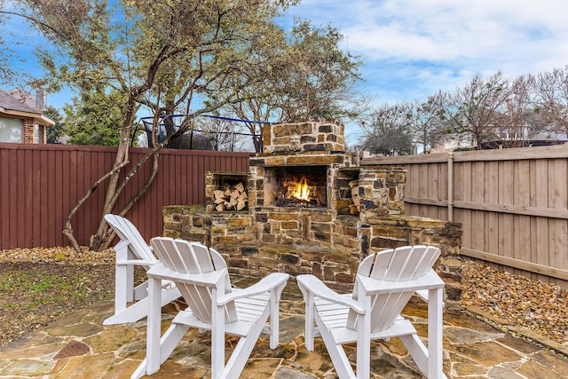 view of patio featuring an outdoor stone fireplace