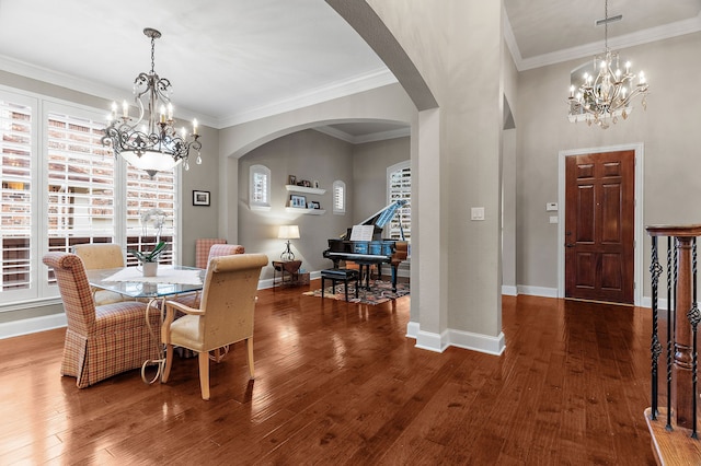 dining area with ornamental molding, a chandelier, and wood-type flooring