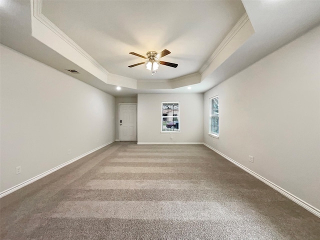 spare room featuring ceiling fan, a tray ceiling, carpet flooring, and ornamental molding