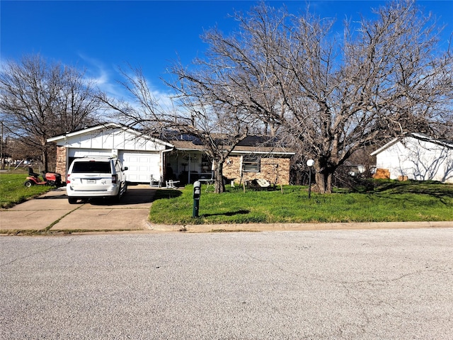 view of front of property with a garage and a front lawn