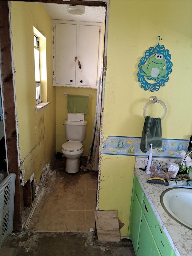 bathroom featuring toilet, tile patterned floors, and vanity