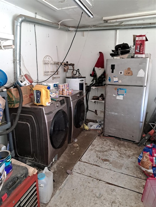 laundry area featuring water heater and washing machine and clothes dryer