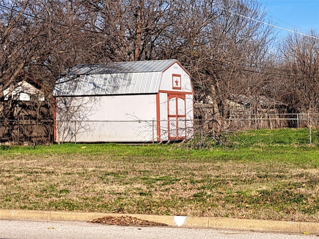 view of outbuilding featuring a lawn