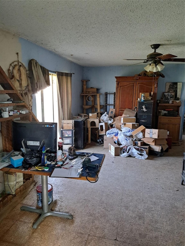 miscellaneous room featuring a textured ceiling and ceiling fan