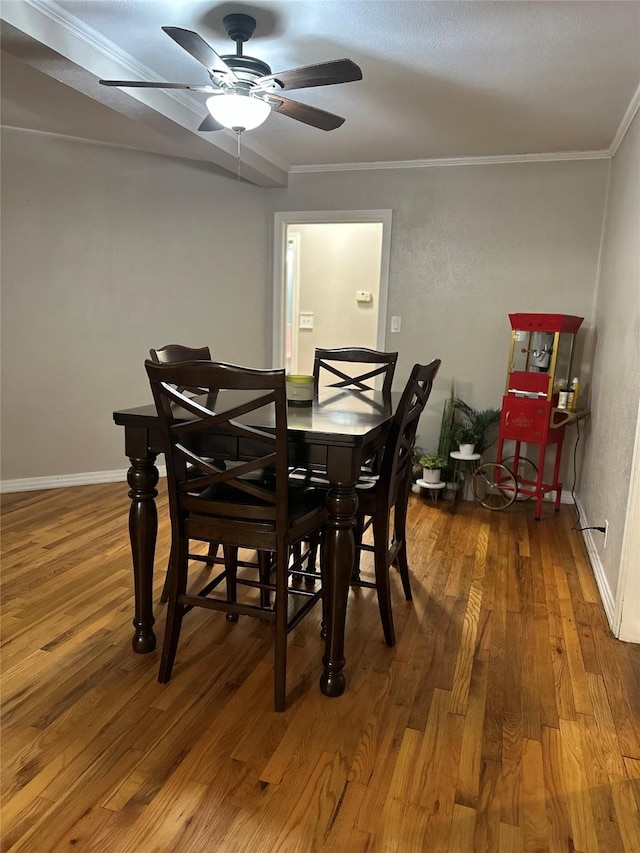 dining area with ceiling fan, hardwood / wood-style flooring, and crown molding