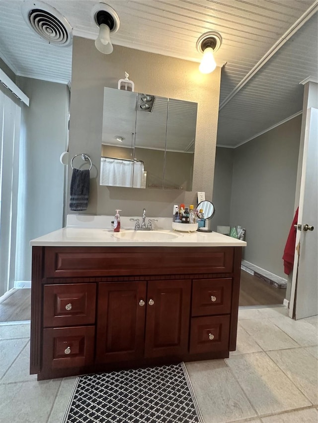 bathroom with vanity and ornamental molding