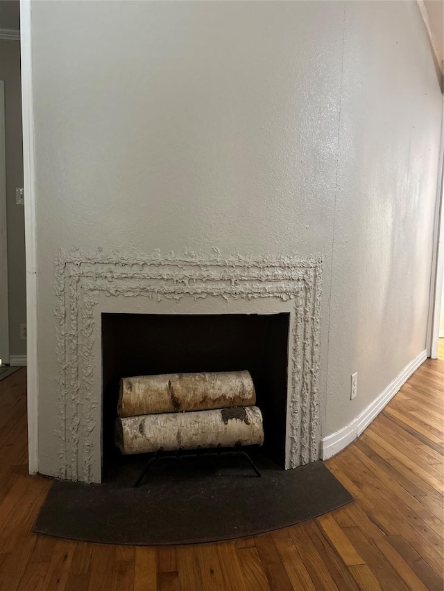 details with a fireplace and wood-type flooring