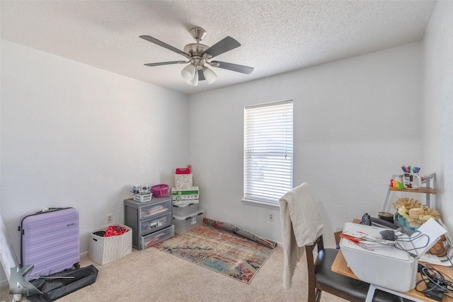 interior space with carpet flooring, ceiling fan, and a textured ceiling