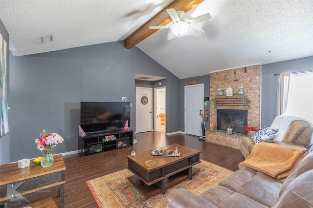 living area featuring vaulted ceiling with beams, dark wood-style flooring, a textured ceiling, and baseboards