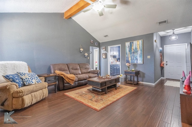 living area with baseboards, visible vents, ceiling fan, dark wood-type flooring, and vaulted ceiling with beams