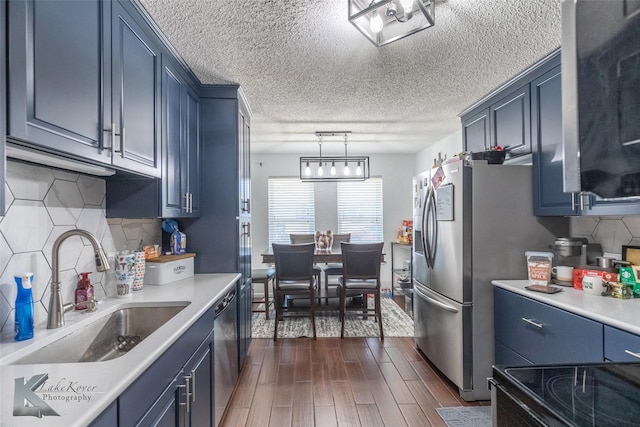 kitchen with light countertops, dishwasher, and a sink