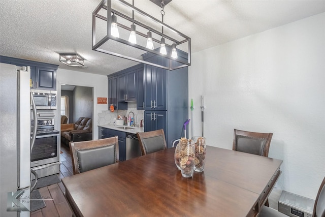 dining room featuring a textured ceiling and wood finished floors