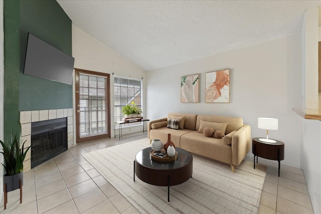 tiled living room with a fireplace, vaulted ceiling, and a textured ceiling