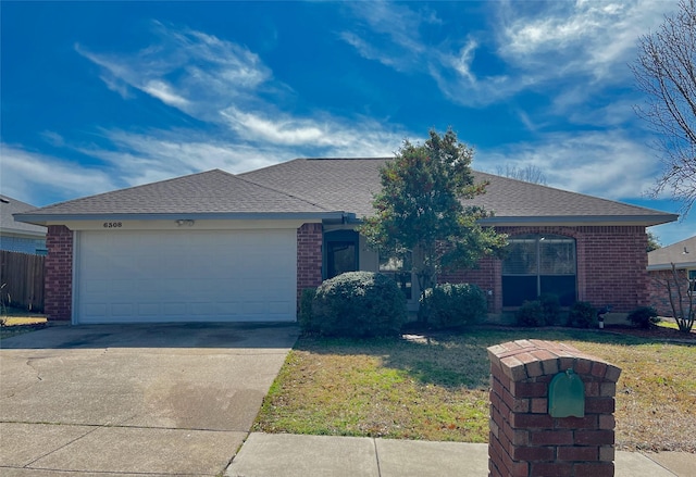 single story home with a front yard and a garage