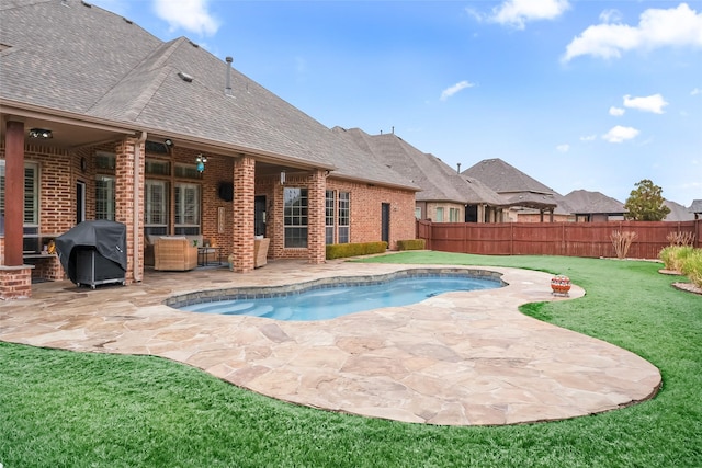 view of swimming pool featuring a fenced in pool, a lawn, a fenced backyard, a grill, and a patio area