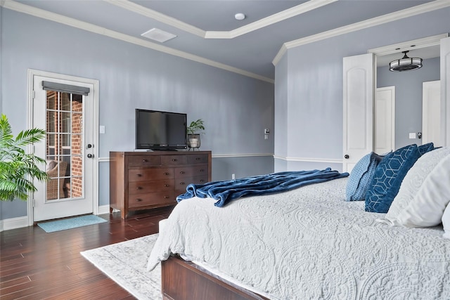 bedroom featuring baseboards, dark wood finished floors, a raised ceiling, access to outside, and crown molding