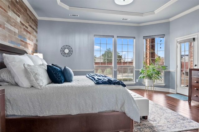 2418 Strathfield Ln, Trophy Club, TX 76262 - bedroom featuring hardwood / wood-style floors, ornamental molding, visible vents, a raised ceiling, and baseboards