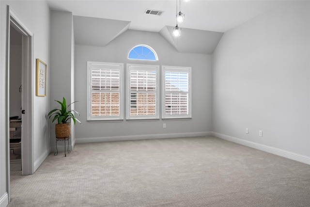 unfurnished room featuring visible vents, vaulted ceiling, light carpet, and baseboards