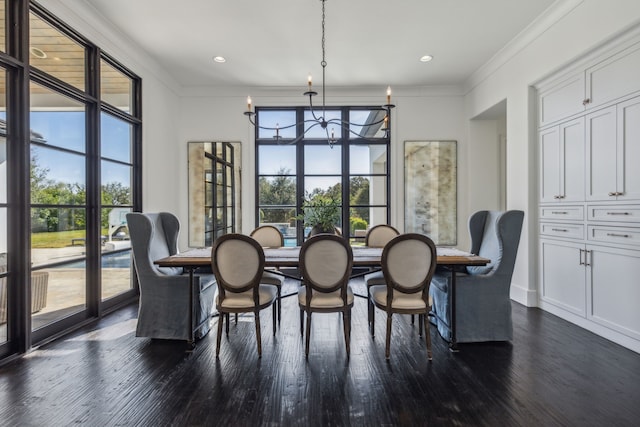 dining area with plenty of natural light, dark wood-type flooring, crown molding, and an inviting chandelier