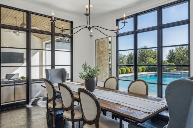 dining room with hardwood / wood-style flooring and an inviting chandelier