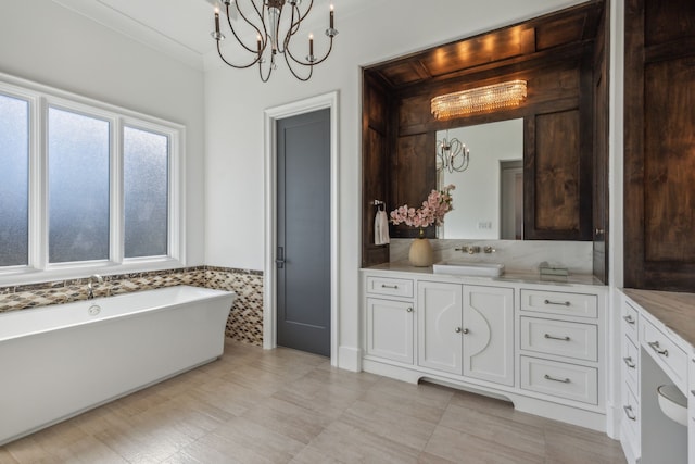 bathroom with tile walls, a bathing tub, vanity, and a chandelier