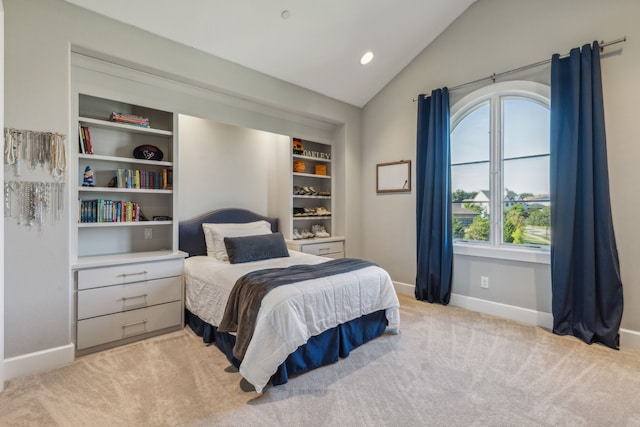 carpeted bedroom with vaulted ceiling