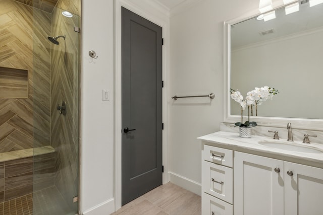 bathroom featuring crown molding, an enclosed shower, and vanity