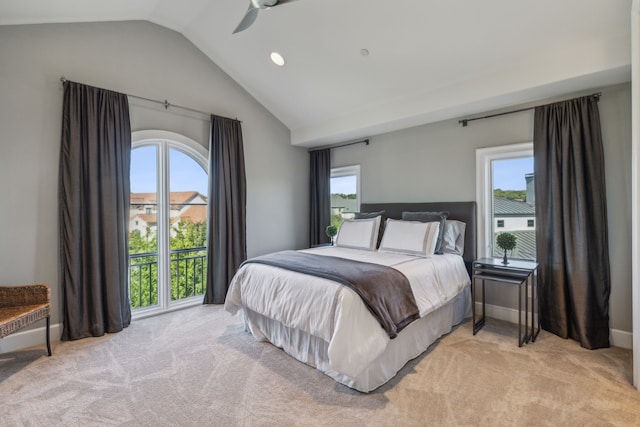 carpeted bedroom with ceiling fan, vaulted ceiling, and multiple windows