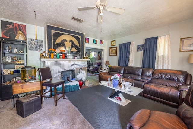 carpeted living room with ceiling fan and a textured ceiling