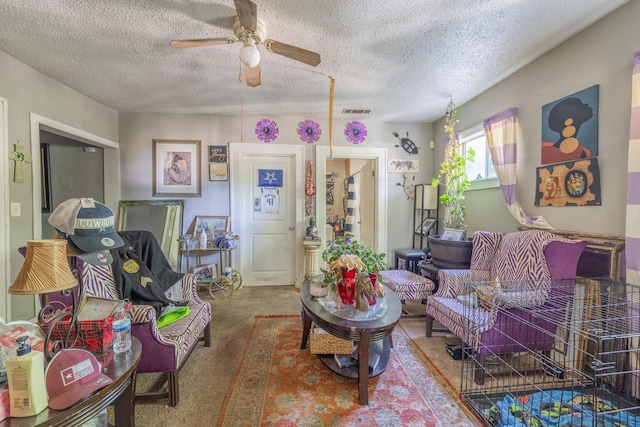 living room featuring carpet floors, a textured ceiling, and ceiling fan