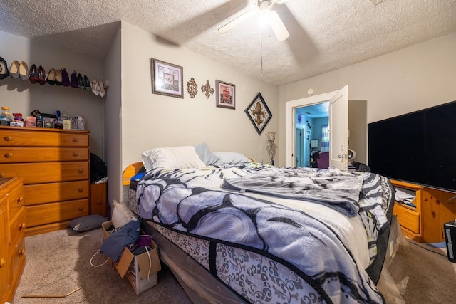 bedroom with carpet, ceiling fan, and a textured ceiling