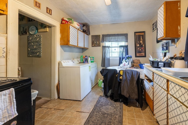 kitchen featuring washer and dryer, black range with electric stovetop, and a textured ceiling