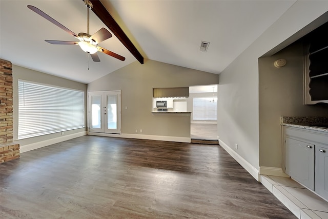 unfurnished living room featuring ceiling fan, lofted ceiling with beams, french doors, and light wood-type flooring