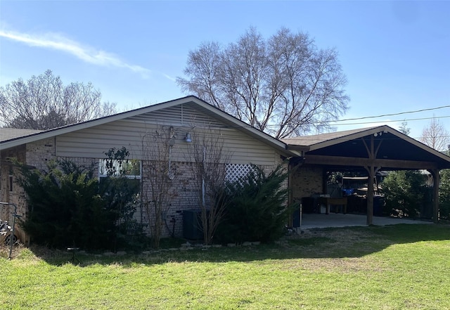 view of property exterior with a yard and a carport