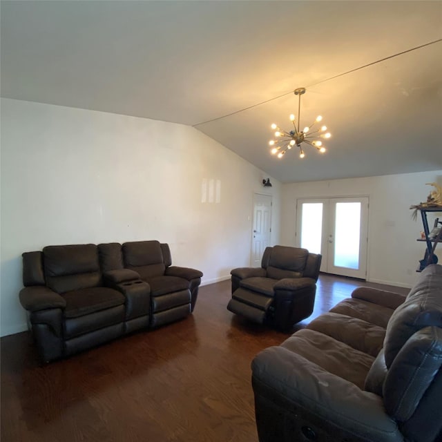 living room with a notable chandelier, vaulted ceiling, dark hardwood / wood-style floors, and french doors