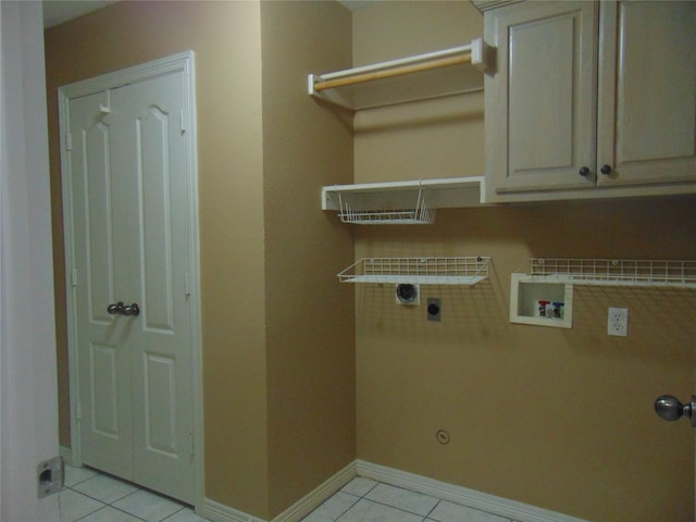 clothes washing area featuring hookup for a gas dryer, hookup for a washing machine, light tile patterned flooring, hookup for an electric dryer, and cabinets