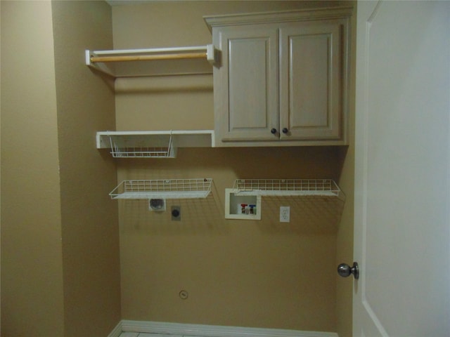 clothes washing area featuring cabinets, hookup for an electric dryer, and hookup for a washing machine