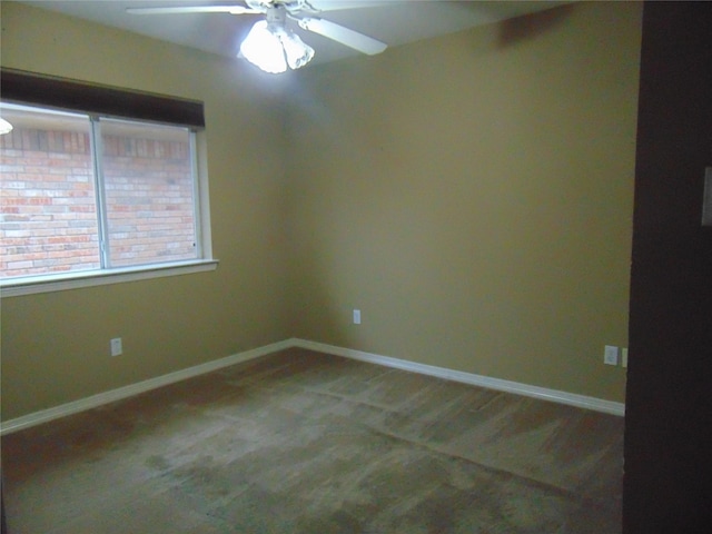 empty room featuring ceiling fan and carpet