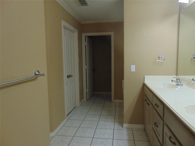 bathroom with crown molding, tile patterned flooring, and vanity