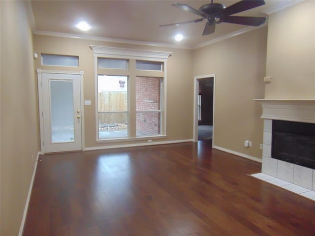 unfurnished living room featuring ornamental molding, a tile fireplace, dark hardwood / wood-style floors, and ceiling fan