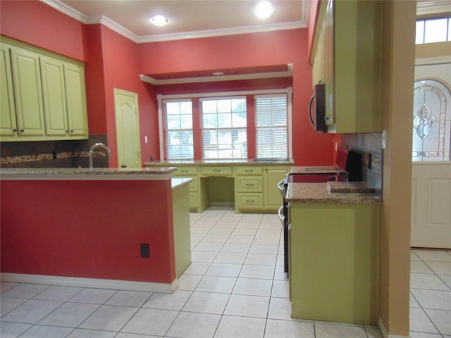 kitchen featuring light tile patterned floors, range, crown molding, and a healthy amount of sunlight