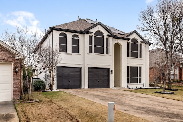 view of front of property featuring a front yard and a garage