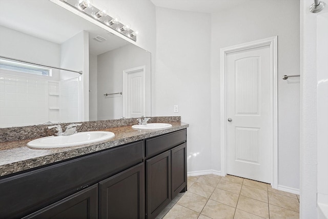 bathroom featuring tile patterned flooring, vanity, and a shower